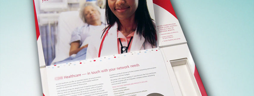 White and red direct mailer for healthcare information with a tabbed booklet insert and a picture on the top of a nurse with a patient in bed in the background