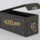 Black turned edge box with #AXELove on the side in gold lettering and the lid open with a silver clasp