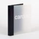 A close up of a light grey binder with a black back binding and the word cardiac across the front