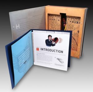 Training box and introduction kit with the kit opened up to an information page and the box opened and displayed behind it