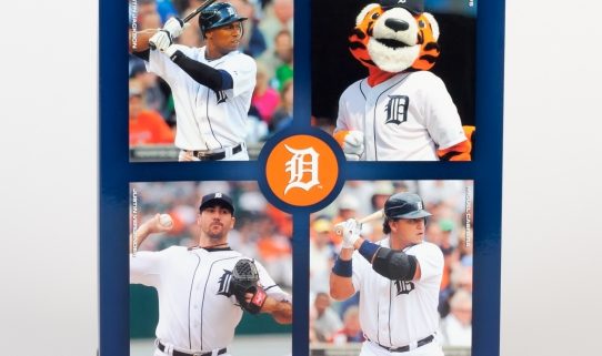 Promotional binder, blue with the Detroit Tigers logo in orange in the center and three baseball players and Paws the mascot around it