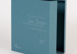 Dark teal colored binder box with magnetic closure and white elegant style writing on the front