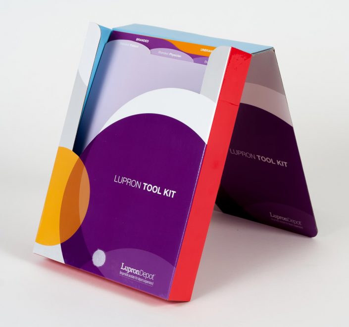 Standup display mailer with purple, orange and white circles, organizational tabs on the inside and red colored sides
