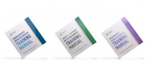 Row of three custom turned edge training manuals, one blue, one green and another purple