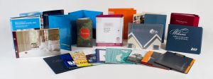 Different customized presentation folders and binders in a variety of sizes and finishes