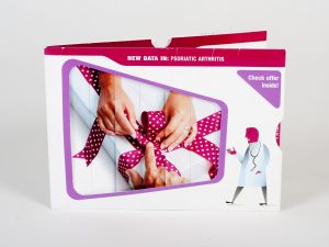 White and red dimensional mailer with a pull out tab for an informational mailer for arthritis.