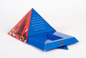 Red and blue pyramid style presentation kit with one side opened and a part on the bottom pulled out to show a cavity for a box