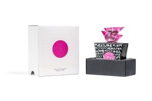 Opened custom folding packaging for perfume bottle, with white top and pink logo next to black bottom half with perfume bottle placed inside