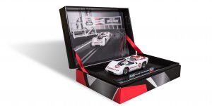 Customized welcome kit with a picture of a race car at a speedway on the opened lid and a small replica of the car on the inside