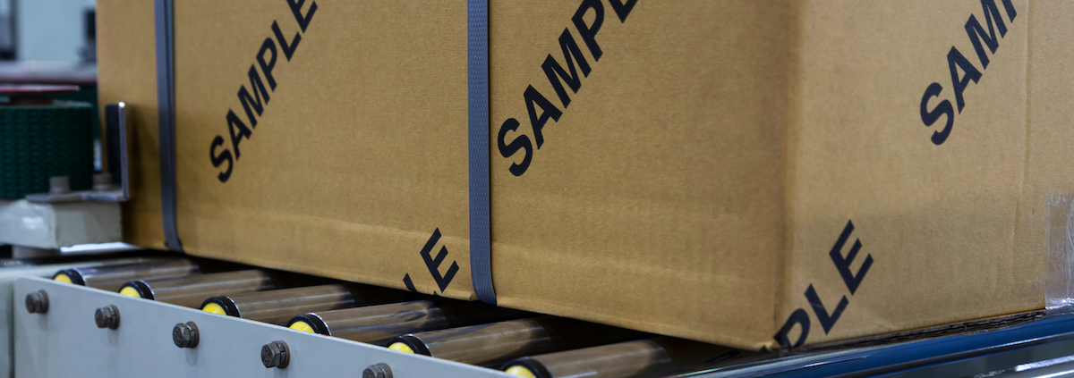 box labeled with sample on a conveyor belt